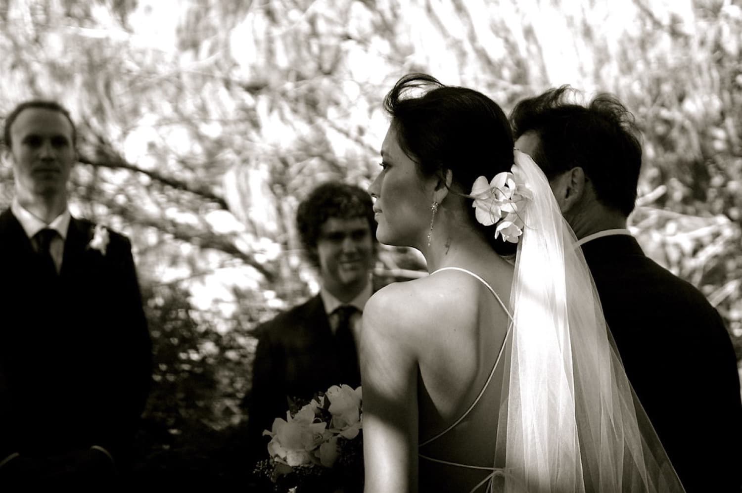 Bride in profile during the ceremony, soft monochrome